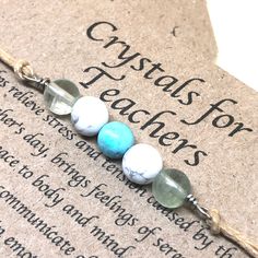 "(Gift wrap available at check out) If you need more than 1 gift wrap, please buy them separetly in my shop. You'll find the option under the section \"Gift Wrap\") This Crystal bracelet has been designed to support teachers in their day to day job, to keep them relaxed, positive and happy so to give their best and to enjoy their demanding job. This bracelet is made up of Howlite, Turquoise and Fluorite crystals beads.  These crystal are traditionally associated with teaching and they are known to provide a general sense of well being. All my crystals are natural in order to preserve all their qualities. *Please note that fluorite, (the two beads on the sides) comes in many colors which they will be selected randomly (shades of green, purple, pink, blue, light yellow, transparent)* Crystal Fluorite Crystals, Crystals Beads, Minimalist Gifts, Fluorite Crystal, Gift Teacher, Drawstring Pouch, Handmade Bracelet, Crystal Gifts, Gift Handmade