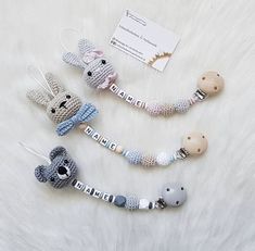 three crocheted keychains with animals on them and a name tag attached