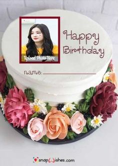 a birthday cake decorated with flowers and a photo