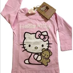 Hello Kitty Organic Long Sleeve Shirt 100% Organic Cotton Fiber Color Pink Size 6-12 Months $20 Hello Kitty Long Sleeve Cotton Top, Long Sleeve Cotton Hello Kitty Top, Kawaii Long Sleeve Top With Cat Design, Pink Long Sleeve Top With Cat Design, Pink Long Sleeve Tops With Cat Design, Hello Kitty Shirts, Hello Kitty Shirt, Christmas Long Sleeve Shirts, Hello Kitty Pink