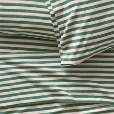 the green and white striped sheets are folded together