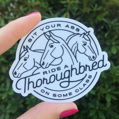 someone holding up a sticker that says ride a thoroughbred on some clubs with horses