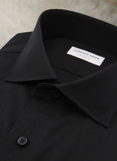 This impeccably designed Liam in Solid Black Freefit Poplin Shirt requires minimal effort for timelessly styling both day and night looks. From smartly-suited to edgy casual, this classic hue pairs seamlessly with black or tan suits as well as chinos or jeans. The easy care technology maintains its original crispness while the hint of stretch in the soft, high-density, long-staple cotton luxury fabric ensures unparalleled comfort. Carefully tailored to do away with any superfluous fabric around the waist, the Liam is suitable for a variety of body types. • Regular: The Liam Fit• Easy Care, Non Iron• Stretch• 98% Cotton, 2% Freefit• Cut-away Collar• Mitered Barrel Cuff• Imported• Item #WH-124 Tan Suits, Tan Suit, Suit Shirt, Luxury Fabric, Suit Shirts, White Label, Night Looks, Poplin Shirt, Day And Night