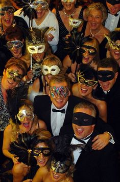 a group of people with masks on posing for a photo