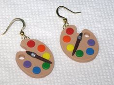 pair of wooden earrings with paint palette and brush