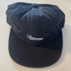 Brand New Never Worn Supreme Hat With Script Logo And Side Pocket With Zipper. Adjustable Strap. Ss18 Collection Classic Black Snapback Hat With Embroidered Logo, Classic Flat Brim Dad Hat For Streetwear, Urban Black Dad Hat With Embroidered Logo, Classic Short Brim Baseball Cap For Streetwear, Classic Black Dad Hat With Embroidered Logo, Classic Black Hat With Embroidered Logo, Trendy Black Dad Hat With Short Brim, Black Six-panel Everyday Hat, Black Six-panel Hat For Everyday