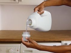 a person pouring milk into a container