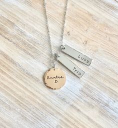 "Aunt Necklace Auntie Jewelry Personalized Jewelry Handstamped Jewelry Name Necklace Handstamped Necklace Charm Jewelry *Auntie necklace with names of loved ones. This necklace makes a loving gift to any member of your family or friends. * A 1\" Rose Gold disc stamped \"Auntie\" with \"Name of choice\" * 1 3/8\" stainless steel bar with name of choice * A 18\" stainless steel chain at check-out, please leave information **names All handstamped jewelry is packaged in gift box. Every piece is a ha Aunt Necklace Gift, Minimalist Hand Stamped Necklace For Personalized Gift, Personalized Dangle Necklaces For Birthdays, Nickel-free Necklace For Mother's Day Personalized Gift, Hand Stamped Necklaces For Mother's Day, Personalized Dangle Charm Necklaces For Birthdays, Personalized Dangle Charm Necklaces For Birthday, Hand Stamped Pendant Charm Necklace For Gift, Adjustable Stamped Necklace For Everyday Wear