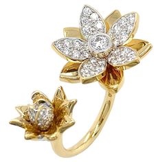 Two radiant flowers bloom in this contemporary designed ring. One on side is smaller flower with its 18k yellow gold petals contrasting against the ornamented petals and bud of brilliant cut diamonds. On the other side a larger flower with pave set open faced petals of brilliant cut diamonds, casting a striking light as gold petals flash in between. At the center of the larger flower is a single brilliant cut diamond. The unique open band allows a flower to sit at each side of the finger. The to Ruby Gold Ring, Expensive Flowers, Flower Diamond Ring, Yellow Gold Cocktail Ring, Mens Gold Jewelry, Gold Cocktail Ring, Gold Cocktail, Flowers Bloom, Mom Jewelry