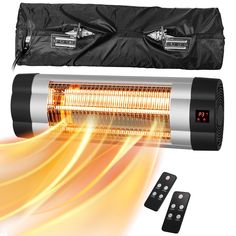 an electric heater with three remote controls on it and a black bag next to it