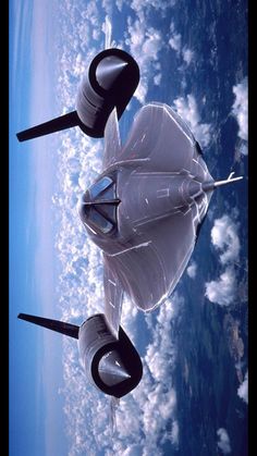 the space shuttle is flying in the sky above the earth's clouds and land