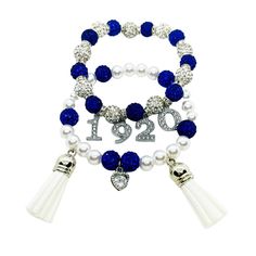 "Zeta 1920 charm bracelet. Set includes 2 blue & white beaded bracelet featuring one bracelet adorning rhinestone 1920 charms & the other showcasing a silver heart charm with two tassels. A perfect, affordable gift for new members (\"neos\") or as a gift for your favorite finer woman on their Founder's Day, crossing anniversary, birthday or just because! The bracelet is constructed on super stretchy, yet durable elastic strings that rests comfortably on wrists without irritation." White Charms Bracelet For Anniversary, White Charms Bracelets For Anniversary, White Charm Bracelet For Anniversary, White Beaded Bracelet, Founders Day, Bracelets Set, Sorority And Fraternity, Affordable Gifts, White Gift Boxes