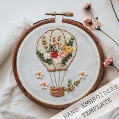 an embroidery project with flowers and a hot air balloon