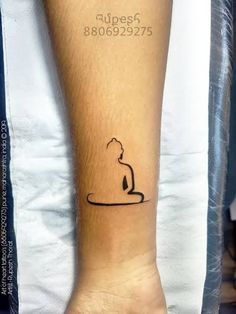 a person's foot with a tattoo on it that has a cat sitting in the water