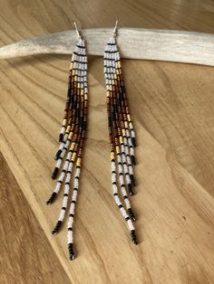 These are a nice long tasseled earring that makes me think of feathers or wings ! These ones are made with fading whites tans and browns into black . These are 6 inches long and a half inch wide . The longest tassel is about to the caller bone. The closer is a silver coated ear wire . pheasant feather inspired Pheasant Feather, Beaded Tassel Earrings, Long Tassel Earrings, Handmade Earrings Beaded, Earrings Beaded, Silver Coat, Earrings Long, Pheasant, Tassel Earrings