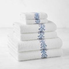 five white towels stacked on top of each other