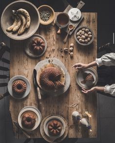 a table topped with plates and bowls filled with food