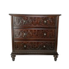 an ornate carved wooden chest with drawers