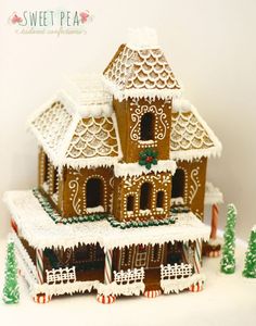 a gingerbread house is decorated with icing and candy canes