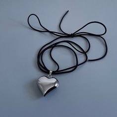 "𝙋𝙐𝙁𝙁𝙀𝘿 𝙃𝙀𝘼𝙍𝙏 𝙎𝙏𝙍𝙄𝙉𝙂 𝙉𝙀𝘾𝙆𝙇𝘼𝘾𝙀 * handmade in Los Angeles * Stainless Steel Puffed Heart Pendant ~ choose between silver or gold * Elastic Cord in Black * 60\" total length Each piece is made by hand Message me with any questions you have, I am happy to help ☺ x Madz Cold Shoulder LA @coldshoulder__" Tie Choker, Puffy Heart Necklace, 3d Pendant, Choker Silver, String Necklace, Indie Jewelry, Pendant Necklace Simple, Dope Jewelry, Puffed Heart