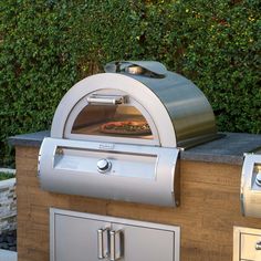 a pizza is cooking on an outdoor grill