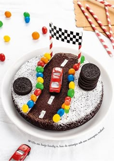 a birthday cake decorated with cars and candy