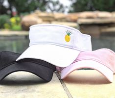 Distinct Headwear Presents... Women's Embroidered Pineapple Visor Pineapple design is full sewn in the visor corner.  Your choice of visor color and thread colors. 🍍Shown on a white visor with the traditional pineapple color. Order as a traditional pineapple color with yellow and green or order one solid color (all black, all hot pink, etc.) If you leave a note at checkout, you can also create your own color combo.   For example a mermaid top with a tangerine bottom or a pink top with a yellow bottom. Price is per visor. Visor will come non-distressed unless distressing is specifically requested at checkout.  FOR BULK ORDERS - Need 10 or more visors or an event? We can special order more colors - send us a message for more options. Not a visor person?  This design can be found in our shop Pool Hat, Beach Visor, Full Sew In, Embroidered Sun, Cruise Gifts, Mermaid Top, Vacation Hawaii, Pineapple Shirt, Sevierville Tn