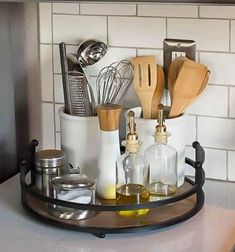 kitchen utensils and cooking utensils are arranged in a tray on the counter