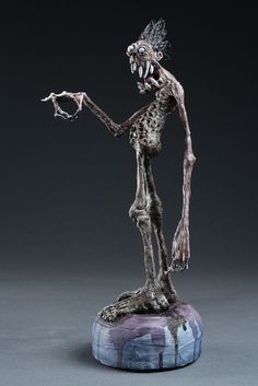 a statue of a skeleton holding something in its hand