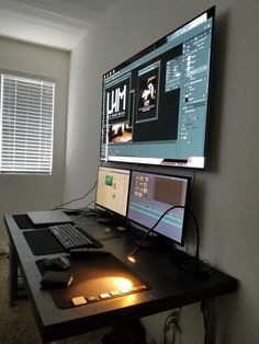 a computer monitor sitting on top of a desk next to a keyboard and mouse in front of a window