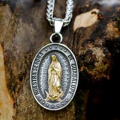 Embrace divine protection with our Guadalupe Medallion. This exquisite pendant features a detailed depiction of Virgin Mary, rendered in a stunning two-tone finish. The central golden figure radiates against an antique silver background, encircled by stars and a meaningful inscription. Crafted with meticulous attention to detail, this piece serves as both a spiritual talisman and a work of art. Whether worn as a personal devotional or gifted to a loved one, this medallion offers a daily connection to faith, hope, and celestial guidance. Vintage-inspired design with strong religious symbolism Premium 316L stainless steel - Lightweight, hypoallergenic and tarnish-resistant Retro chain included (24 inches length) With bail 45mm x 28. Without bail 35mm x 28mm Virgin Mary Pendant - Symbol of Pu Silver Our Lady Of Guadalupe Pendant Jewelry, Silver Virgin Mary Pendant Jewelry, Silver Spiritual Virgin Mary Jewelry, Spiritual Silver Jewelry With Virgin Mary, Spiritual Silver Necklace With Our Lady Of Guadalupe, Lady Of Guadalupe Necklace, Guadalupe Necklace, Virgin Mary Pendant, Silver Background