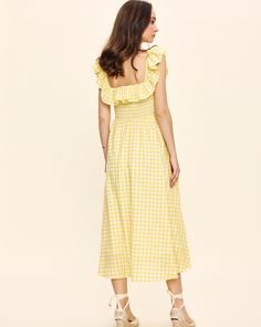 Louise New York creates its collection with the past and present in mind. Inspired by timeless glamour instead of trends, when you slip into a Louise New York dress, you carry all the confidence and carefree attitude that femininity can acclaim. The Annabelle Dress in Yellow Gingham is an effortless must-have for your summer wardrobe. This silhouette boasts a stretch shirred bodice and a lightweight, easy movement. Product Details Cotton. Made in NYC. Care Instructions Dry-clean only. Size & Fit Gingham Dress With Smocked Back For Garden Party, Chic Gingham Maxi Dress For Summer, Picnic Plaid Midi Dress With Ruffles, Plaid Midi Dress With Ruffles For Picnic, Chic Summer Plaid Maxi Dress, Chic Plaid Maxi Dress For Summer, Chic Midi-length Plaid Dress For Picnic, Chic Midi Length Plaid Dress For Picnic, Chic Plaid Midi Dress