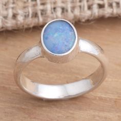 Opal's intense beauty is perfectly showcased in this ring by Caine. He sets the fascinating gem on sterling silver its elegance benefiting from the rich contrast between metal and gem. .925 Sterling silver