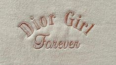 a white towel with the word,'dear girl forever'written in red on it