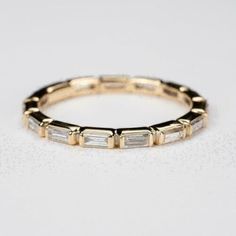 an image of a gold ring with baguettes