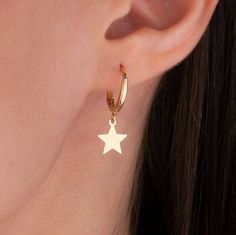 Our star charm earring is 14k solid gold and it has a star charm that dangles on it. It's an earring that looks beautiful on your all outfit. Thanks to its closure, our gold star hoop earring is comfortable enough to wear every day. If you are searching for a gift for your loved ones, this dangle star earring will be a perfect choice. It makes happy your loved ones on mother's day, birthdays, valentine's day, anniversaries, Christmas, or graduations. The gold star hoop earring's inner diameter i Yellow Gold Star Huggie Earrings For Gift, Star-shaped Hoop Earrings With Dangling Charms For Gift, Star Shaped Hoop Earrings With Dangling Charms For Gift, Star-shaped Hoop Earrings With Dangling Charms, Yellow Gold Huggie Earrings With Star Charm, Gift Star Charm Dangle Huggie Earrings, Star Charm Dangle Huggie Earrings As Gift, Gift Dangle Huggie Earrings With Star Charm, Gift Huggie Earrings With Star Charm Dangle