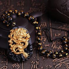 Unleash the Fury of the Dragon! Kings of the spirit world, dragons fear nothing. In Eastern culture, the Yellow Dragon 黃龍 is the fifth element of Earth and the God at the center of the Cosmos Are you ready to release the dragon? ☯ 18K Carved Gold Dragon ☯ Black Onyx Beaded Necklace ☯ Black Onyx Pendant Shenron Dragon, God At The Center, Japanese Accessories, Fear Nothing, Beaded Necklace Black, Yellow Dragon, Anime Fashion, Golden Dragon, Japanese Dragon