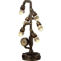 When you are looking for a steampunk way of lighting up a room with a macabre twist, then be sure you check out the Steampunk Crystal Skull Clock Lamp. Made from cold cast bronze, this hand-painted lamp has six bulbs that light up with LEDs. Each bulb looks like a clear skull. These bulbs screw into housings that look like plumbing pipes. Together they have a single stem that continues into a round base. A fully functional clock branches off the main stem. The round base has red and brass-colore Painted Lamp, Plumbing Pipes, Pipe Lamp, Painting Lamps, Clock Shop, Crystal Skull, Plumbing, Light Up, Office Decor