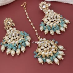 Kundan and pearl Chandbali earring and mangtika set in sky blue, green and white color. Inspire your style with lightweight kundan and pearl tika set.  Earring and tika set is made from brass in gold finish.  All orders Ship same day if placed before 4:00 PM EST  Earring Length: 2.5 inch Earring Width: 1.15 inch Mangtika Length: 6.5 inch Create beautiful memory for any occasion with elegant jewelry for your loved ones We will be happy to navigate you through the process so if you have any questi Earrings And Mangtika Set, Turquoise Kundan Earrings For Wedding, Turquoise Earrings For Wedding And Diwali, Traditional Blue Bridal Earrings With Stone Work, Blue Kundan Earrings For Wedding, Blue Chandbali Earrings For Wedding, Blue Kundan Wedding Earrings, Blue Kundan Bridal Earrings For Wedding, Blue Kundan Jhumkas For Wedding