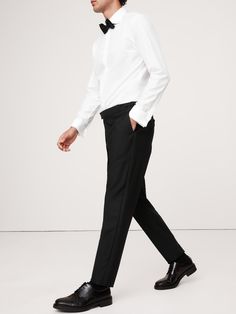 Exquisitely tailored, these timeless tuxedo pants offers elevated style that stands up to the seasons.  Made from Italian virgin wool, our designers employed a classic Barathea weave, classic faille side stripes and our tailored slim fit for a natural look that's especially polished.  Button tabs at the waist offer a customizable fit.  Tailored slim fit: Slim through the leg with a bit of extra length for a distinctive break at the hem.  Fabric from Italy's Marzotto mill.  Zip fly with button cl Semi-formal Tuxedo Pants With Pressed Crease, Timeless Semi-formal Dress Pants, Formal Tuxedo Bottoms With Welt Pockets, Slim Fit Tuxedo For Business Casual, Modern Tailored Formal Pants, Tailored Modern Formal Pants, Modern Tailored Pants For Formal Occasions, Modern Slim Fit Formal Bottoms, Tailored Modern Pants For Formal Events