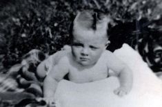 an old black and white photo of a baby