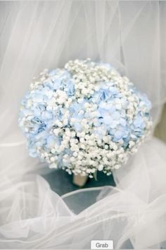 a bridal bouquet with blue and white flowers