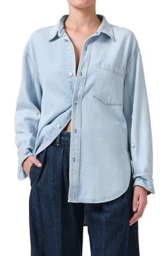 The classic button-up shirt breaks away from its tailored reputation in this soft, oversized chambray version featuring billowy sleeves and a high-low hem. 30 1/2" front length, 32" back length (size Medium) Front button closure Spread collar Long sleeves with button cuffs Chest patch pocket 70% lyocell, 30% recycled cotton Machine wash, tumble dry Made in the USA Relaxed Fit Light Wash Shirt For Workwear, Classic Button-up Blouse For Casual Gatherings, Light Wash Button-up Blouse With Button Closure, Oversized Tops With Snap Buttons For Everyday, Light Wash Collared Blouse With Button Closure, Light Wash Long Sleeve Shirt For Work, Relaxed Fit Light Wash Shirt With Snap Buttons, Light Wash Shirt With Snap Buttons And Relaxed Fit, Classic Oversized Tops With Buttoned Pockets