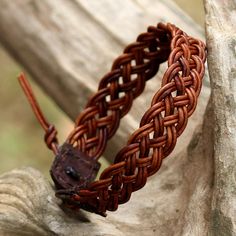 Featuring a handwoven design by local Thai artisans, this wristband bracelet is crafted from leather cord in a brown color. Chaloemphon presents the adjustable bracelet, closing with a silver button that is handcrafted by Karen hill tribe silversmiths. Woven Leather Bracelet, Braided Leather Bracelet Tutorial, Diy Bracelets For Men, Braided Leather Bracelet Diy, Leather Bracelet Diy, Leder Diy, Leather Braiding, Leather Cord Jewelry, Diy Leather Bracelet