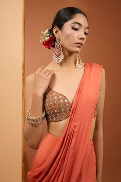 Rust orange pre-draped saree with asymmetric panel detailing. Paired with beads, sequins and mirror embroidered blouse. - Aza Fashions Orange Pre-draped Saree For Party, Elegant Orange Pre-draped Saree With Unstitched Blouse, Party Wear Orange Georgette Pre-draped Saree, Orange Georgette Pre-draped Saree For Party, Elegant Orange Pre-draped Saree For Wedding, Elegant Orange Blouse Piece With Traditional Drape, Elegant Orange Blouse With Traditional Drape, Elegant Orange Blouse Piece For Designer Wear, Orange Pre-draped Saree With Dupatta For Party