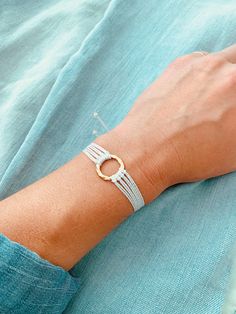 This boho-style string bracelet is super cute and would make a great gift! The bracelet is adjustable to fit almost any wrist size! Stack it with other bracelets, or wear it by itself! It is perfect for everyday wear!  ✦ PLEASE NOTE ✦  When you first receive this bracelet, it may feel slightly waxy, which may make it more difficult to adjust. The waxy texture does not last. After a day or two of wearing, the waxy texture will fade, and it will be much easier to adjust. It will still be waterproof and comfortable! ∙ ∙ ∙ ∙ ∙ ∙ ∙ ∙ ∙ ∙ ∙ ∙ ✦ BRACELET MATERIALS ✦  * White High-Quality Waxed Polyester Cord (This cord is waterproof!) * Gold Circle Charm ∙ ∙ ∙ ∙ ∙ ∙ ∙ ∙ ∙ ∙ ∙ ∙ ✦ QUESTIONS/PROBLEMS ✦ If you have any questions, please feel free to ask! I hope to provide a positive experience for m Dainty Adjustable Bracelets For Festivals, White Braided Bracelet With Adjustable Cord, Dainty Adjustable Cord Bracelet, Dainty Bracelet With Adjustable Cord, Adjustable Dainty Bracelets For Beach, Adjustable Dainty Bracelet For Beach, Dainty Adjustable Bracelets For Beach, Adjustable Dainty Braided Bracelet, Adjustable Cord Bracelet For Everyday Wear