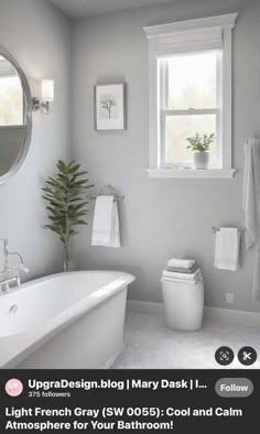 a white bath tub sitting under a bathroom window