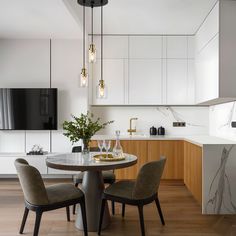 a dining room table with four chairs around it