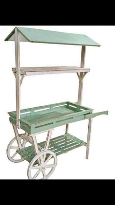 a green and white cart with a shelf on the top that is attached to it