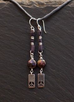 handmade/unique/one of a kind/ one world jewelry/ more than skin deep/ more than us/ pay it forward/ givingthroughjewelry/ empathic warrior/ GIVINGTHROUGHJEWELRY Peace, solitude, serenity. These handcrafted earrings are of sterling silver,  fresh water pearls and earth conscious hand dyed cotton fiber.  The color of purple smoke and incense. Wind chimes on your ears. These measure 2.75 in.,(7cm.) in total length. 10% of this sale will go to buyer's choice of charity. Please leave choice in note Adjustable Nickel-free Spiritual Jewelry, Artisan Oxidized Adjustable Jewelry, Earthy Hand Wrapped Jewelry For Everyday, Earthy Handmade Jewelry For Everyday, Earthy Hand Wrapped Everyday Jewelry, Adjustable Artisan Earrings For Everyday, Spiritual Oxidized Dangle Jewelry, Artisan Adjustable Earrings For Everyday, Nickel-free Symbolic Jewelry For Everyday